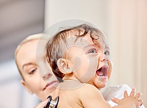 Sick baby, crying and medical woman with stethoscope for check up, healthcare and illness in family clinic. Child