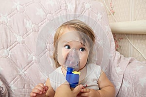 Sick baby girl use nebulizer mask for inhalation, respiratory procedure by pneumonia or cough for child