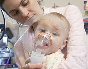 Sick baby with nebulizer mask