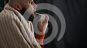 Sick bearded man using spray medication for relief of painful sore throats, cough. Pharmaceutical product. Healthcare