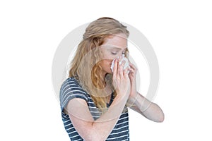 Sick blonde woman blowing her nose