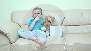 Sick boy with aerosol inhaler holding teddy bear toy friend, friendship, for better and for worse