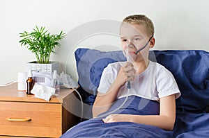 Sick boy breathing through nebulizer, inhaler for treatment prevention, such as coronavirus, asthma, allergies