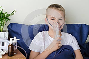 Sick boy breathing through nebulizer, inhaler for treatment prevention, such as coronavirus, asthma, allergies