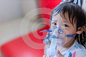 Sick boy inhalation therapy by the mask of inhaler. Baby has asthma and need nebulizations. Patient Boy use inhalation with Nebuli photo