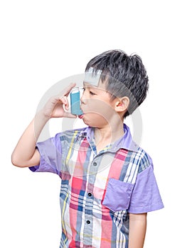 Sick boy using inhaler for asthma