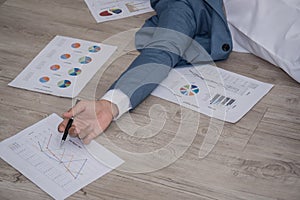 Sick business man laying down unconsciously on floor near his re