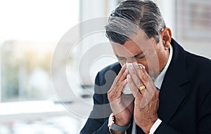 Sick business man, tissue and blowing nose for allergies, cold and virus in law firm. Face of mature lawyer sneeze with