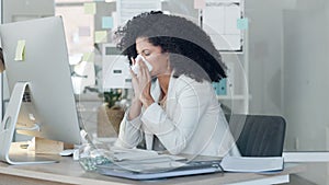 Sick business woman looking unwell while blowing her nose and working in an office. Female suffering with sinus