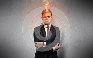 Sick businessman with burning head concept