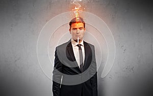 Sick businessman with burning head concept