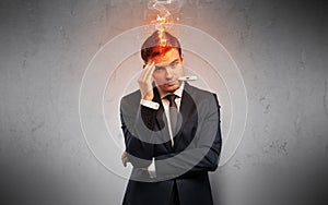 Sick businessman with burning head concept