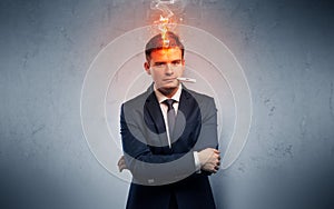 Sick businessman with burning head concept