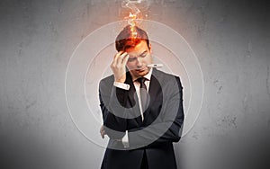 Sick businessman with burning head concept