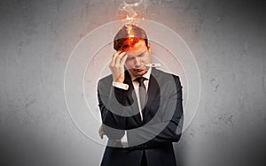 Sick businessman with burning head concept