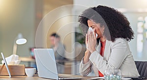 Sick businesswoman blowing nose with a tissue and suffering from flu virus or sinuses while working on a laptop in a