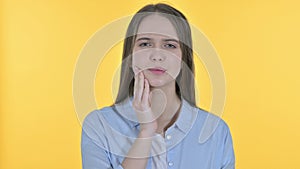 Sick Casual Young Woman having Toothache, Yellow Background