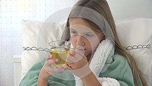 Sick child drinking tea, ill kid in bed, suffering girl, patient in hospital