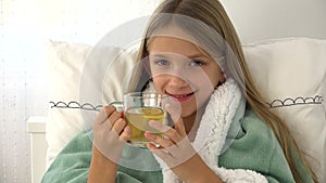 Sick child drinking tea, ill kid in bed, suffering girl, patient in hospital