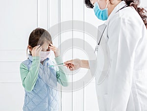 Sick child with flu fever  and doctor  masure with  thermometer