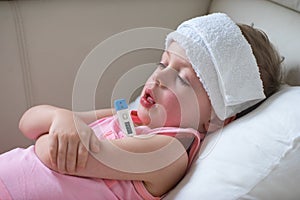 Sick child with high fever laying in bed