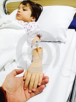 Sick child on hospital bed
