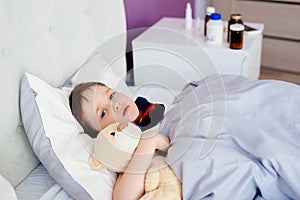 Sick child hugging a teddy bear