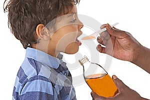 Sick child taking syrup against cough or flu