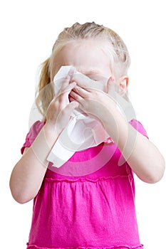 Sick child wiping or cleaning nose with tissue isolated