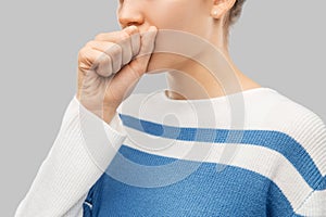 Sick coughing teenage girl in pullover