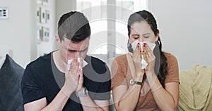 Sick, couple and blowing nose in home, allergies or cold virus on living room sofa together. Tissue paper, man and woman