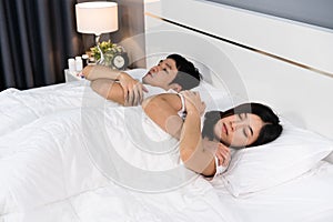 Sick couple feeling cold and suffering from virus disease and fever on bed
