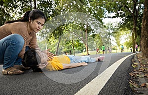 Sick daughter is fainted and fallen on floor,asian mother help, take care,exhausted teenage girl with heat stroke,high temperature