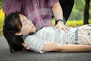 Sick daughter is fainted and fallen on floor while playing and exercise,asian mother help,take care, child girl with congestive