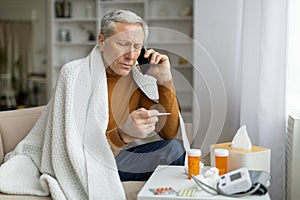 Sick elderly man have phone conversation with doctor