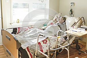Sick, elderly senior woman in a hospital bed