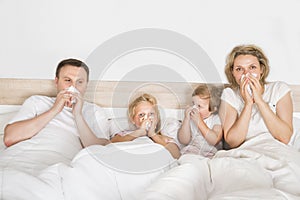 Sick family lying in bed photo