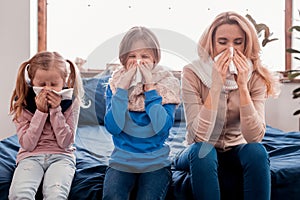 Sick family sitting on the bed