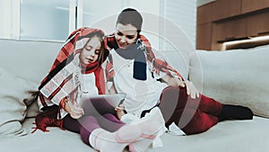 Sick Family Sitting on Sofa in Checkered Blankets.