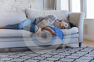 Sick frustrated adult homeowner woman getting heat stroke