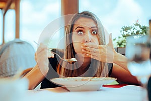 Woman Eating Soup in a Restaurant Feeling Sick