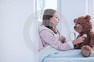 Sick girl and teddy bear