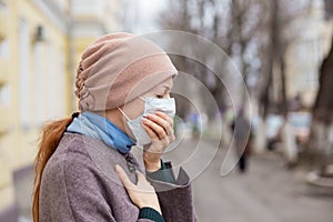 Sick girl wearing surgery medical mask feeling ill being hit by the coronavirus