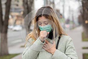 Sick girl wearing surgery medical mask feeling ill being hit by the coronavirus
