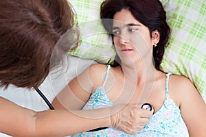 Sick hispanic woman having a heart examination