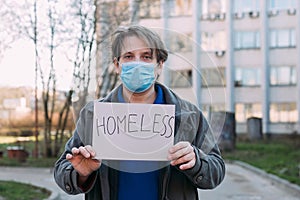 Sick homeless in a medical mask caught a cold photo