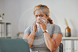 Sick, ill, or unwell business woman suffering with a cold, flu or sinus infection and sneezing or blowing her nose with