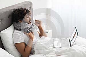 Sick indian man talking to doctor, using laptop