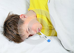 Sick Kid with Thermometer