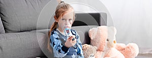 Of sick kid using inhaler with